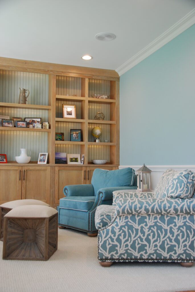 A coastal-style living room with beach inspired colors and patterns.