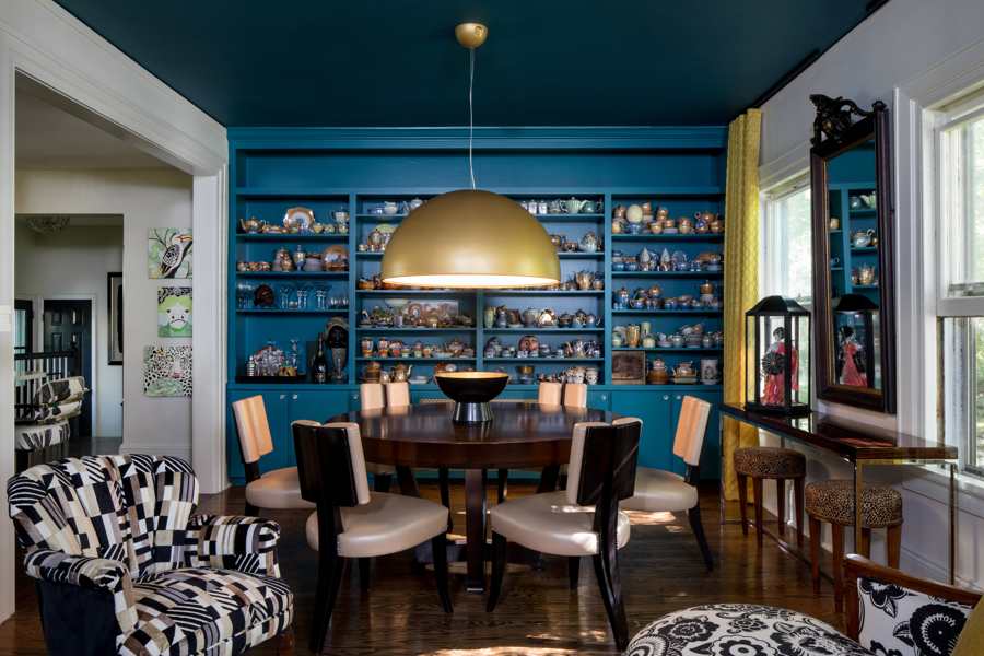 After image of a dining room with colorful paint and a large chandelier. 